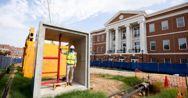 Project Manager Jared Tackett stands in a section of the steam tunnel that is being replaced along Wheeler Mall this fall. The steam delivers heat and hot water to buildings on the western side of campus, including Wheeler and Cox residence halls